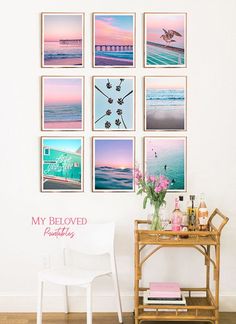 a white chair sitting in front of a table with pictures on the wall above it