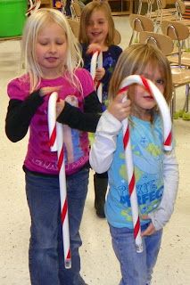 three children holding candy canes in their hands