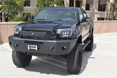 a black truck parked in a parking lot