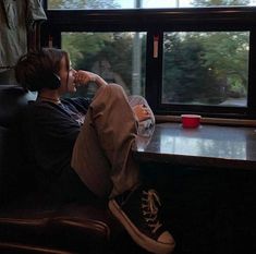 a person sitting on a train looking out the window