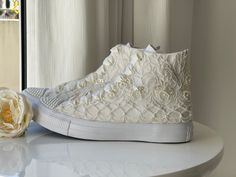 "There are many great benefits to wearing sneakers with your wedding dress - the most obvious is comfort. With a comfortable pair of tennis shoes on your feet, you will not have to avoid the track, you can easily do the laps at your reception and you will not wake up in the morning with unwanted blisters. The ivory lace with pearls in this dreamy couple is 100% worthy of a wedding. SIZE: Tip.. Its size Converse is smaller than other companies (eg. if you Nike wear 40, wear Converse 39) ★If you h All White Wedding Converse, Wedding Converse Bride High Top, Custom Bridal Converse, Lace Converse Shoes, Embellished Lace-up Sneakers For Weddings, Wedding Converse Sneakers & Athletic Shoes, Bride Converse, Wedding Sandals For Bride, Custom Converse Shoes