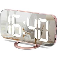 an image of a cell phone with the clock on it's side and its reflection