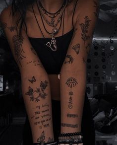 a woman with lots of tattoos on her arms