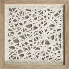 a white frame with an intricate pattern on the front and back of it, made out of paper