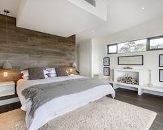 a large bed sitting inside of a bedroom on top of a hard wood flooring