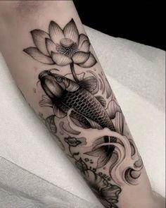 a fish and flower tattoo on the leg