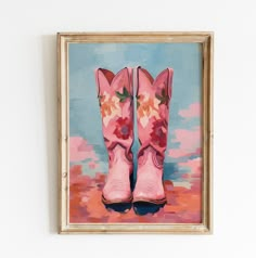 a painting of pink cowboy boots with flowers on them