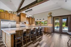 a large kitchen with wooden cabinets and an island