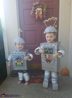 two children dressed up in costumes standing next to each other