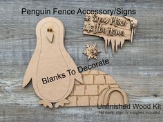 a wooden penguin with an iglot and snowflake sign on it's back