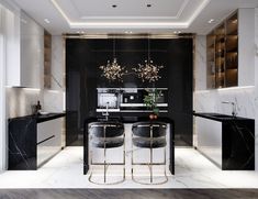 a black and white kitchen with marble counter tops