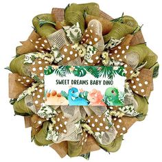 a wreath that says, sweet dreams baby dino on the front and back with polka dots