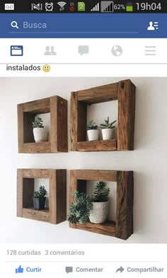 three wooden boxes with plants in them on the wall