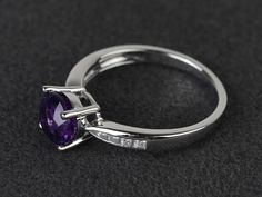 Welcome to my shop, you can find many beautiful gemstone jewelry here, and you also can ask for customized service. Main Stone: natural amethyst, round cut, measures 7X7mm, weight about 1.23 carats.Accent Stones: czMetal: 925 sterling silver plated with rhodium. I also can provide metal options such as 14k solid yellow/white/rose goldSetting: prong settingmore rings: https://www.etsy.com/shop/XCjewelryStudio?ref=hdr_shop_menuIt's a perfect gift for the person who was born in February (Birthstone Purple Brilliant Cut Rings For Promise, Sterling Silver Amethyst Ring With Brilliant Cut For Promise, Amethyst Ring In Brilliant Cut Sterling Silver For Promise, Brilliant Cut Amethyst Ring In Sterling Silver For Promise, Brilliant Cut Amethyst Ring In White Gold, Purple Ring With Center Stone, White Gold Amethyst Ring With Brilliant Cut, White Gold Amethyst Ring With Round Cut, White Gold Amethyst Ring Round Cut