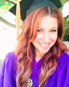 a young woman wearing a purple graduation gown