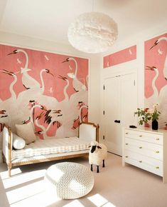 a bedroom with flamingos on the wall and white furniture