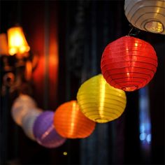 colorful paper lanterns are hanging from the ceiling