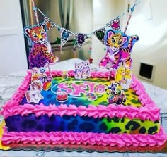 a birthday cake decorated with colorful icing and decorations