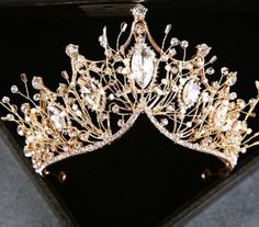 YAS QUEEN! This year TAKE THE CROWN. Beautiful & baroque describes this gorgeous crown tiara that is fit for a Queen. Rising to over 3 inches tall and approximately 6 inches at it's base, this crown give a dramatic and whimsical impression. Over 3" Tall 6" Base Available in gold & silver, these crystal stones add a stunning sparkle with silver & gold that shows up great in photoshoots. 1-2 Day Processing Time. Shipping Method for regular orders: USPS 1st Class Mail 2-7 Days FedEx - Next Day Rush Silver Jumpsuits, Floral Embroidery Dress, Rhinestone Bra, Colorful Gemstones, Skirt Tulle, Silver Tiara, Pearl Tiara, Black Lace Bodysuit, Diamond Tiara