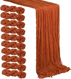 an orange rope is tied to the side of a white wall and next to it are several different colors of yarn