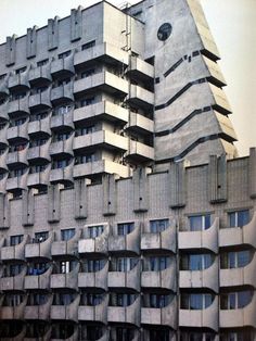 a tall building with many balconies on the side