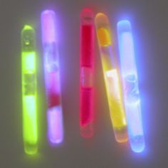 four different colored lightsticks sitting next to each other