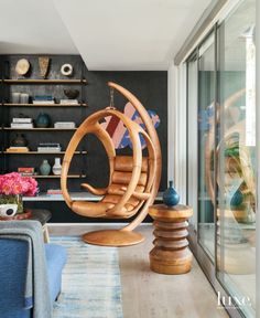 a living room filled with furniture and lots of shelves next to a sliding glass door