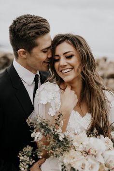 a bride and groom smile at each other