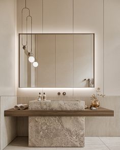 an elegant bathroom with marble counter tops and large mirror above the sink, along with hanging lights