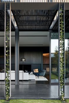 an outdoor living area with black and white furniture