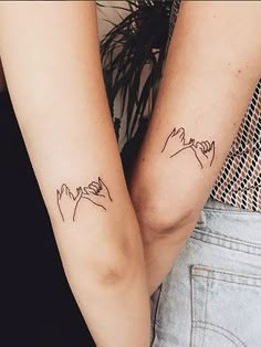 two people with matching tattoos on their arms