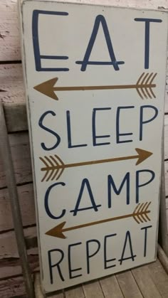 a sign that says eat, sleep, camp and repeat with arrows pointing to the right