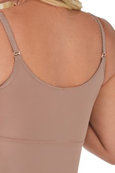 Your new wardrobe staple has arrived: the Tank Top Shaper. This multi-use garment shapes and sculpts your back and abdomen while lying invisible under clothes. This reversible basic allows you to wear either a V-neck or scoop-neck cut. Can be worn as a regular tank top or under clothes Reversible with V-neck and scoop neck Dual compression fabric gives you a tight and toned fit Soft, stretchy, and smooth to the touch Lightweight fabric with a cooling effect High-quality materials and smart compression technology Adjustable straps for the perfect fit Size and Fit Model with mocha shaper Weight: 130 lb Height: 5'4'' Pants size: 3 Model is wearing a size S Model with black shaper Weight: 170 lb Height: 5'8'' Pants size: 9 Model is wearing a size L Versatile Seamless Shapewear, Stretch Scoop Neck Top With Removable Bra Pads, Stretch Scoop Neck Shapewear With Built-in Bra, Stretch Shapewear With Built-in Bra And Scoop Neck, No-show Shapewear With Built-in Bra, Stretch Shapewear With Medium Bust Support And Scoop Neck, No-show Elastane Shapewear With Built-in Bra, Shaping Scoop Neck Shapewear With Built-in Bra, Shaping Shapewear With Built-in Bra And Scoop Neck