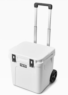 a white cooler with wheels and handles on it's side, in front of a white background