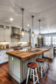 a kitchen with an island and stools in it