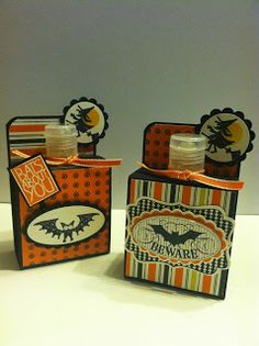 two halloween treat boxes with orange and black designs on the front, one is empty