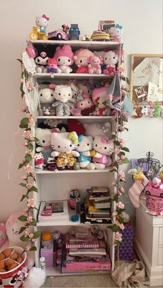 a shelf filled with lots of different types of stuffed animals and other items on top of it