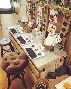 an assortment of items are on display in a room with wooden flooring and chairs