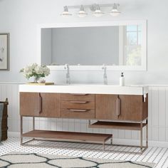 a bathroom with a sink, mirror and rug