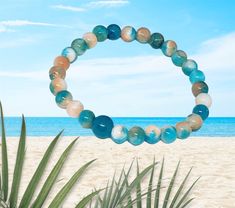 This simple, yet gorgeous stretch bracelet is made with natural jade, white, blue and peach round, smooth 6 mm beads. It is the perfect bracelet for the beach and for those warm summer days🏝☀️🏝☀️.  This is a stretch bracelet made with 100% polyester stretch cord (not wire). Please refer to the last picture when ordering your bracelet size. BEAD COLORS WILL VARY WITH EACH BRACELET!  The matching necklace (sold separately) is available in my Etsy shop. Bohemian Stretch Bracelet For Beach, Bohemian Round Stretch Bracelet For Beach, Beach Stretch Bracelet With Gemstone Beads, Stretch Bracelet With Gemstone Round Beads For Beach, Beach Stretch Bracelet With Round Gemstone Beads, Vacation Stretch Bracelet With Round Beads, Natural Stones Stretch Bracelet With Round Beads For Beach, Hand-strung Crystal Bracelet With Round Beads For Beach, Beach Bracelet