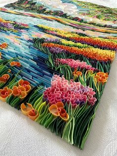 an image of colorful flowers in the field on display at a museum or art gallery