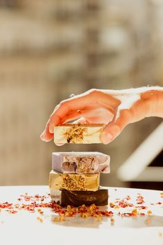 a person reaching for some food on top of a white table with confetti sprinkled all over it