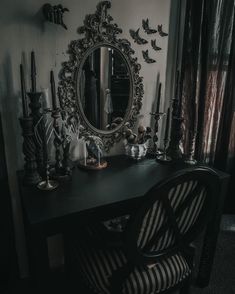 a desk with a mirror and some candles on it