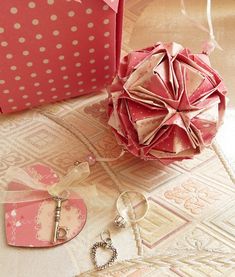 an origami ball, keychain and other items are on the floor