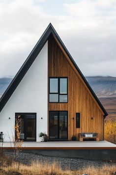 a house with a wooden roof and white walls