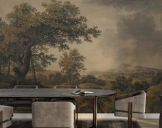 a dining room table with chairs and a painting on the wall behind it that looks like a forest