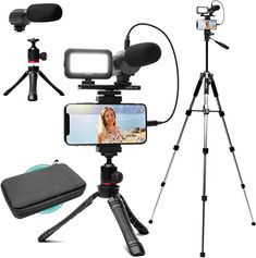 a tripod with a cell phone, camera and other items to take pictures on