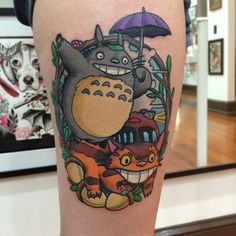 a tattoo with totoro and other cartoon characters on it