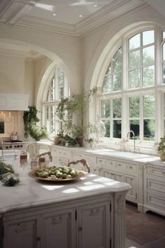 a large white kitchen with lots of windows