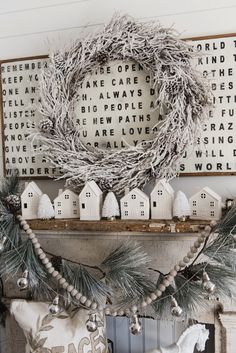 a mantle decorated with christmas decorations and wreaths